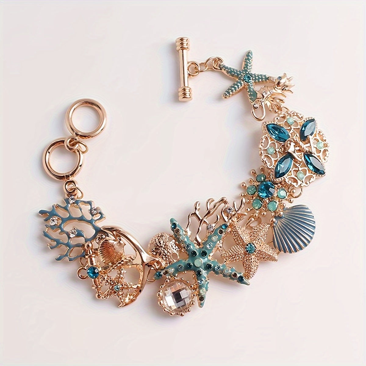 Gold Tone Sea Life Bracelet with Starfish & Blue Gems