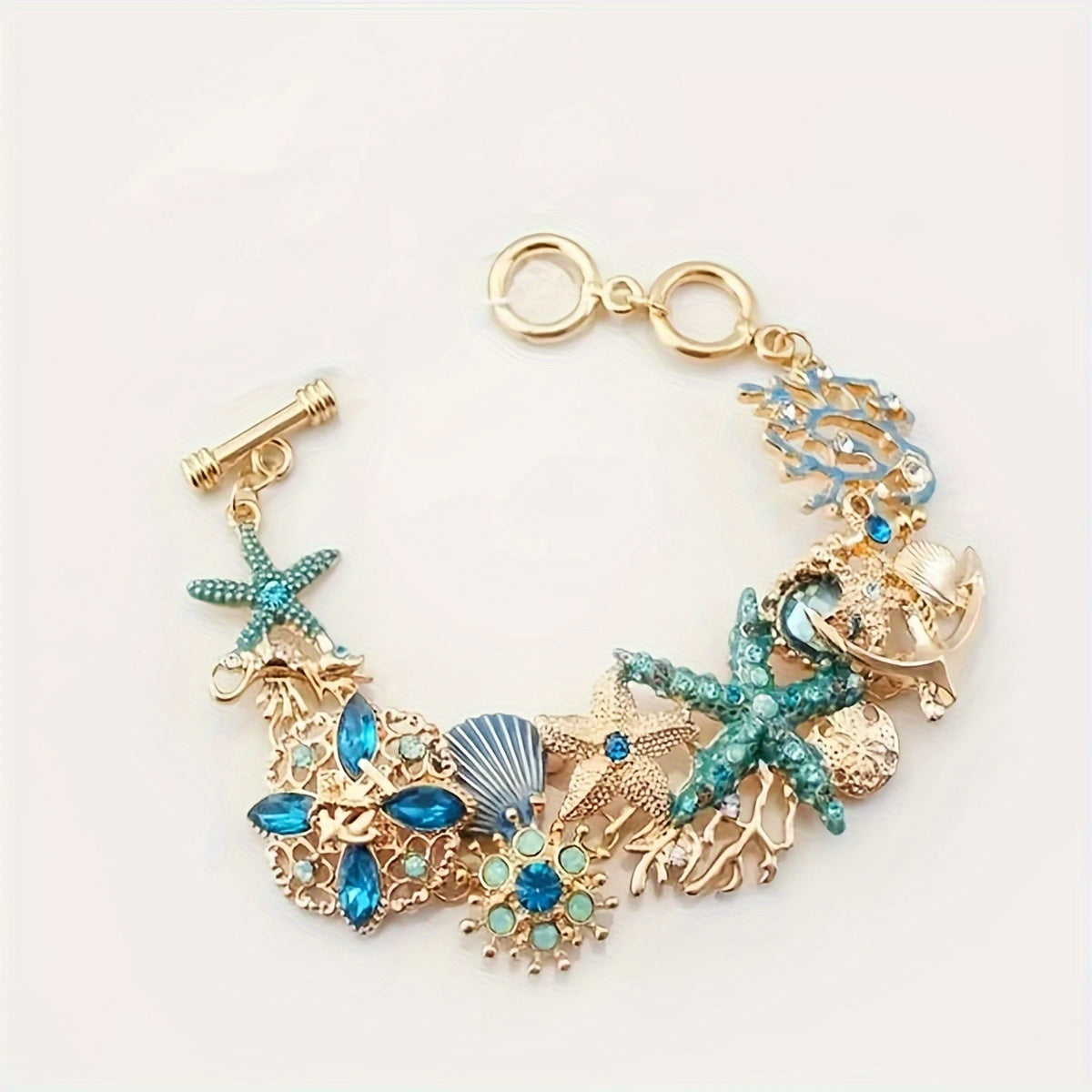 Gold Tone Sea Life Bracelet with Starfish & Blue Gems